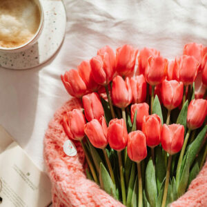A Bouquet of Red Tulips next to a Cup of Coffee - Image