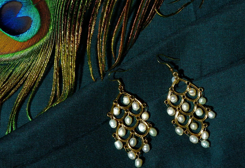 Peacock Feather with a pair of Pearl Earrings Image