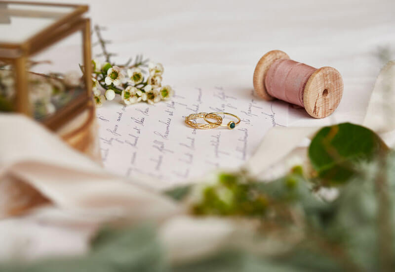 Wedding rings with a spool of thread Image